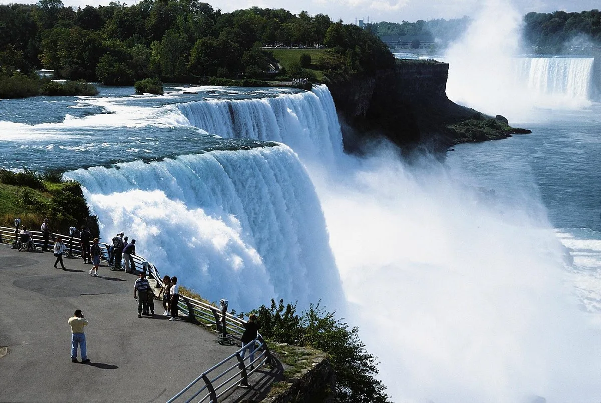 Horseshoe Falls with a Niagara City Cruises boat in the rising mist on the Canadian side, seen near dusk